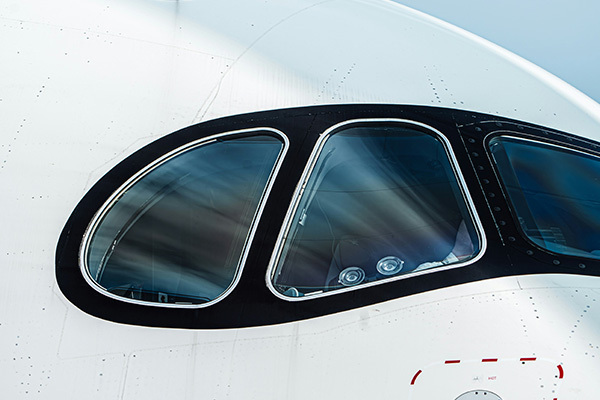 Closeup of a commercial jet's cockpit windows.